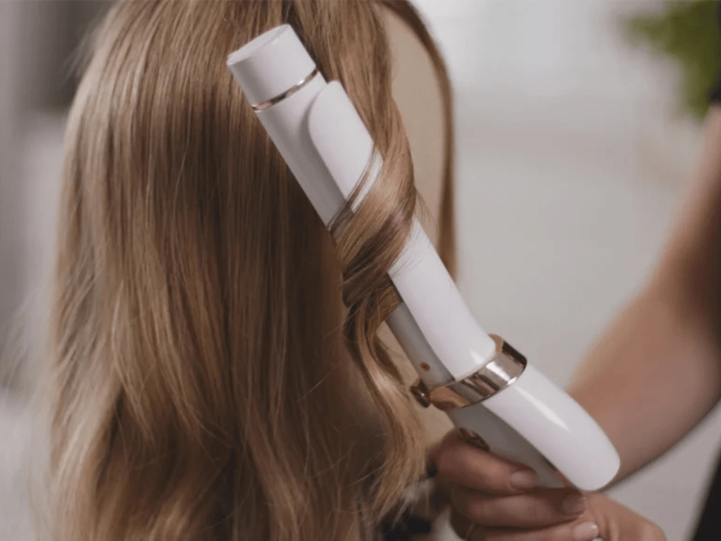 Take a small piece of hair and wrap it around the curling tool