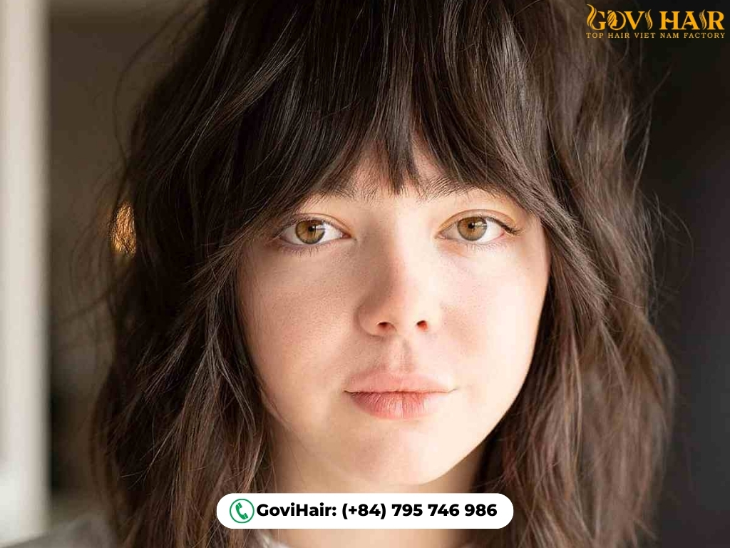 Bob-length wolf cut with layered texture and tapered bangs