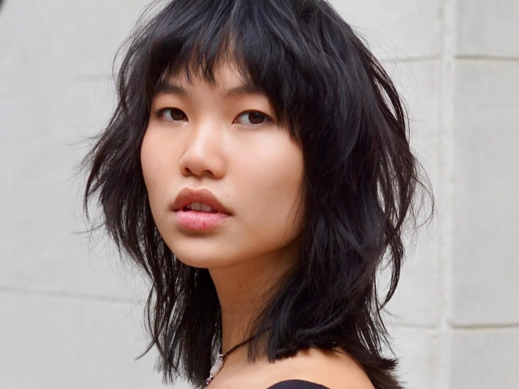 Collarbone-length wolf cut with face-framing layers