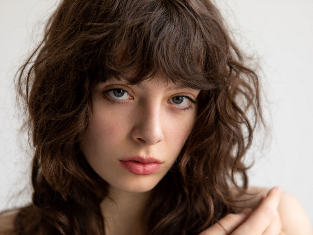 Curly-texture wolf cut with defined layers