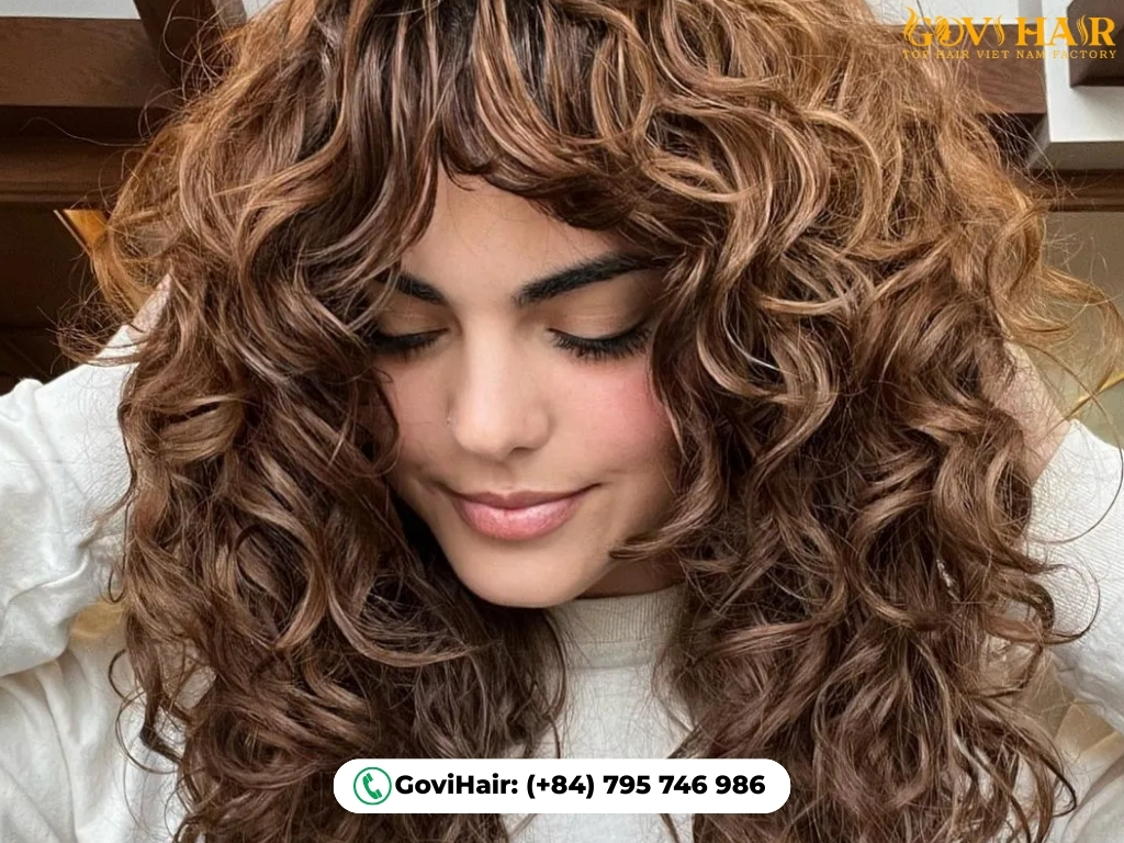 Curly wolf cut with face-framing curtain bangs