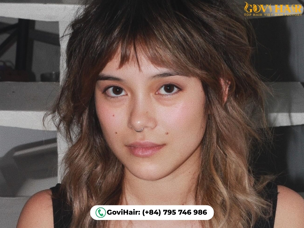 Layered wolf cut with soft, wispy Korean-style bangs