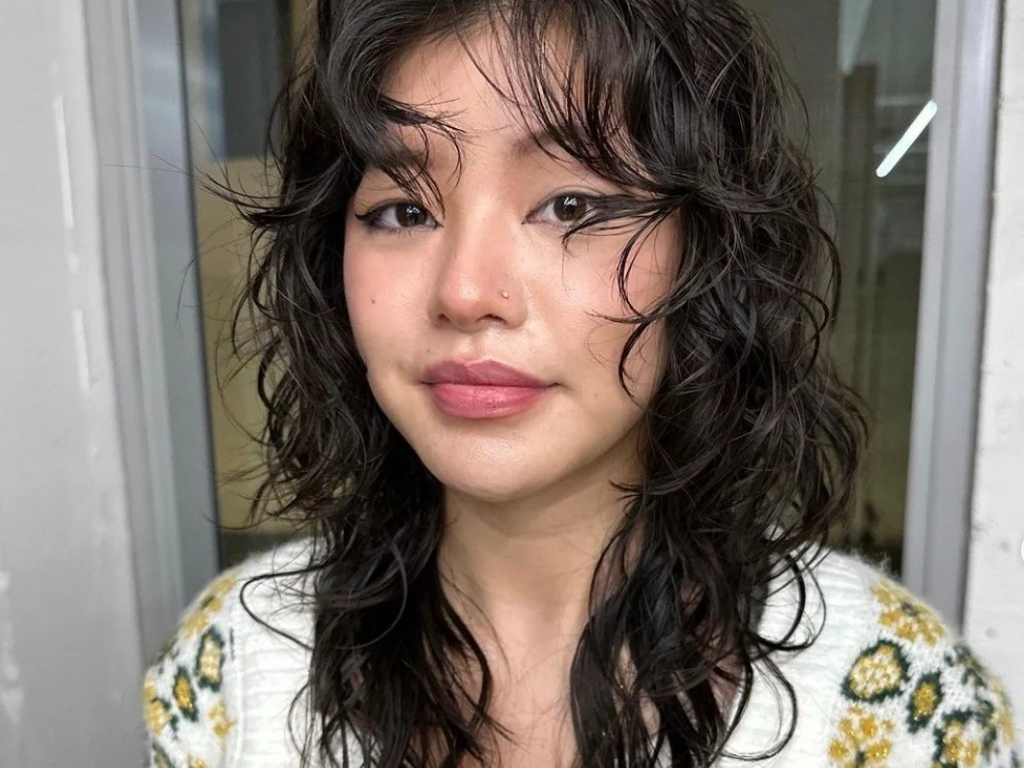 Sleek glossy wolf cut with sharp, wet-look layers