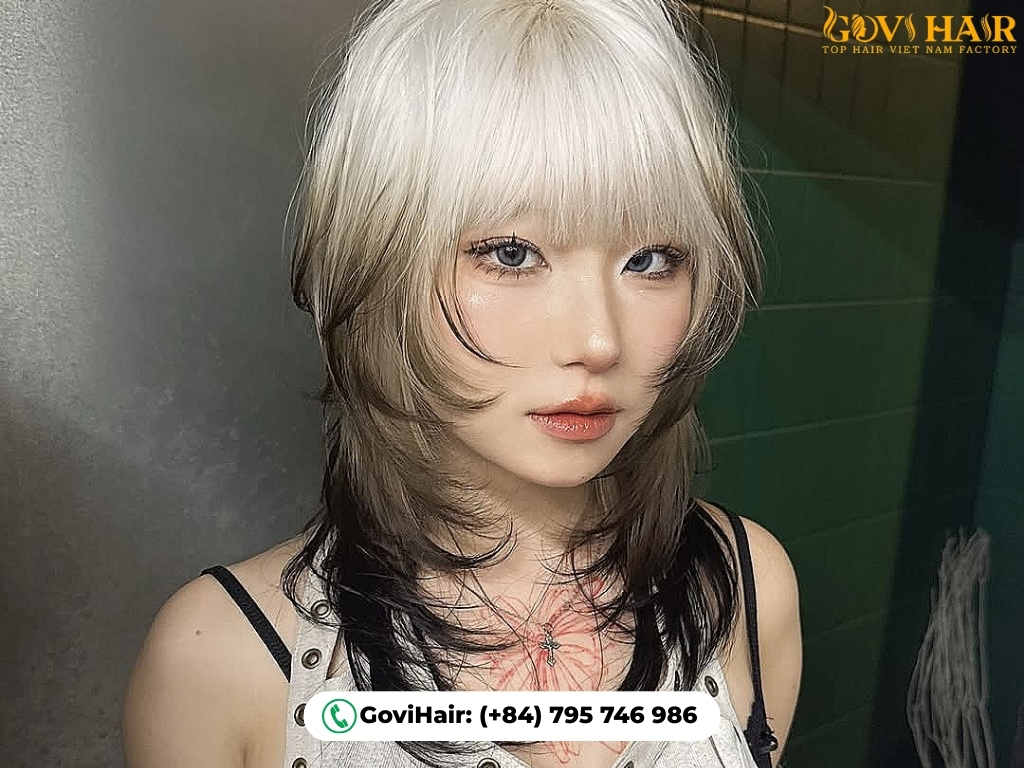 Sleek layered wolf cut with sharp, straight bangs