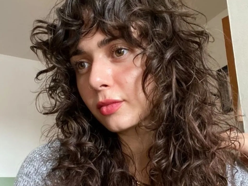Voluminous curly wolf cut with bold, full texture
