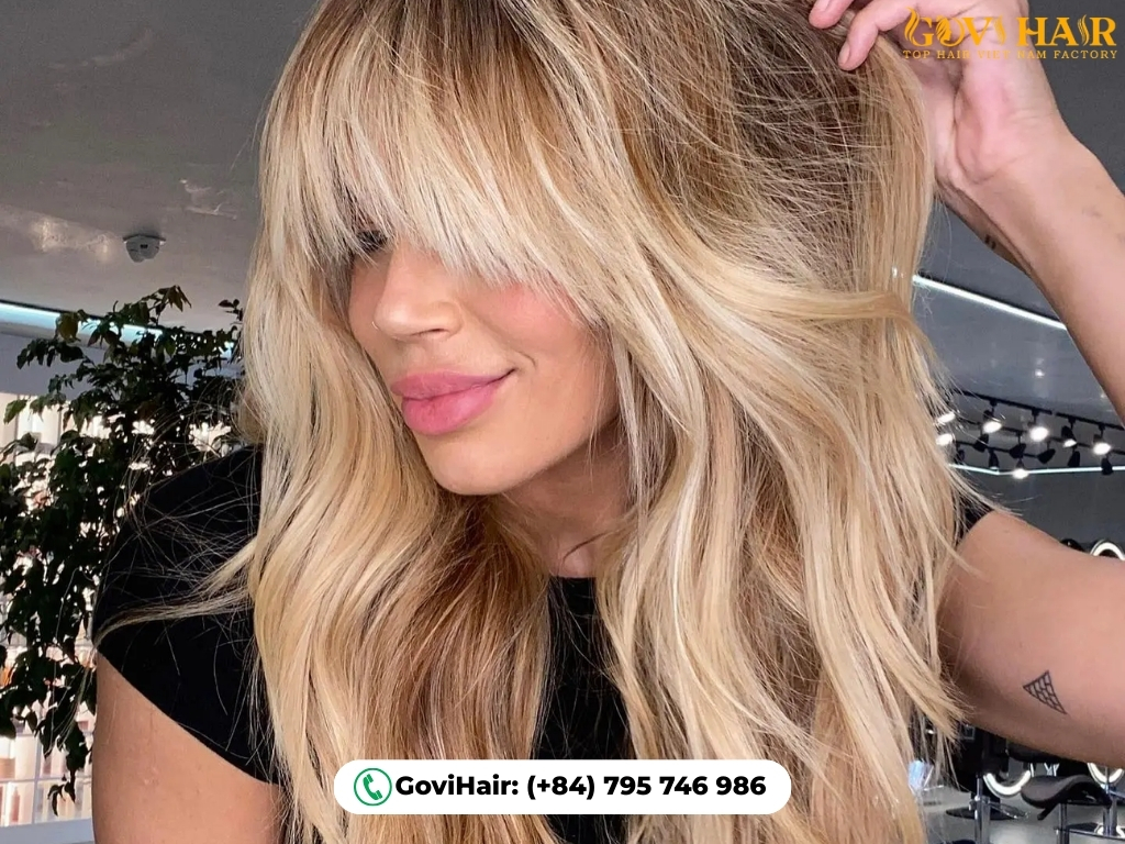 Voluminous wolf cut with iconic Bardot-style parted bangs