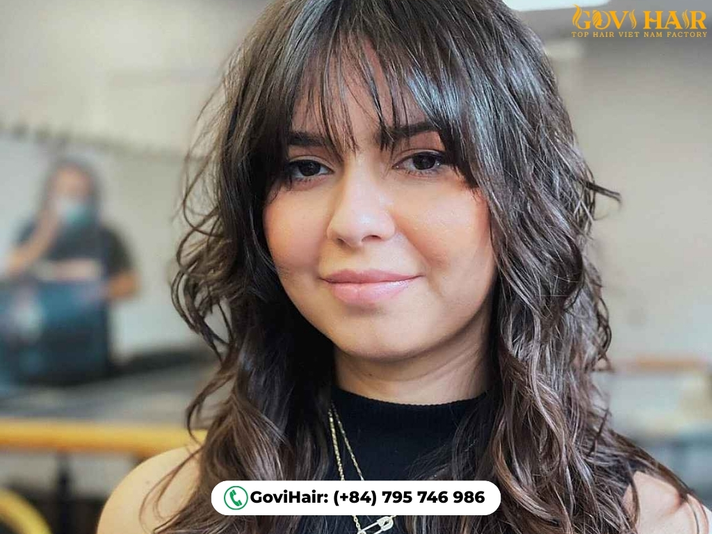 Wavy wolf cut with choppy, boho-inspired bangs