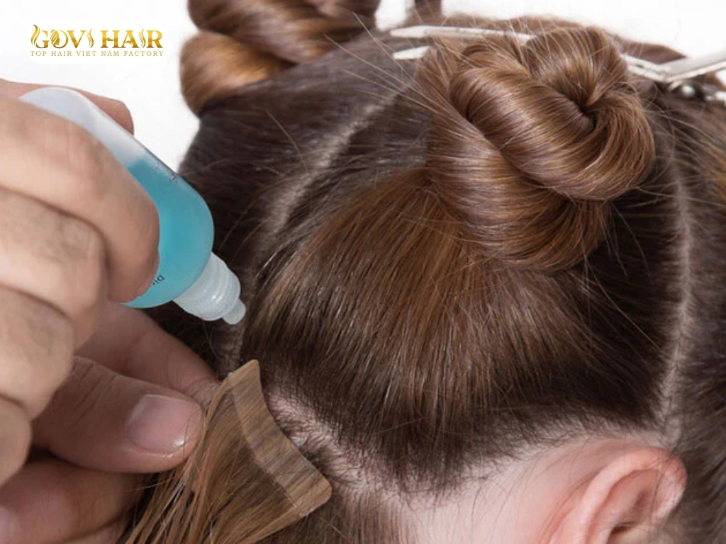 The safe removal of tape-in hair extensions with a bond remover 