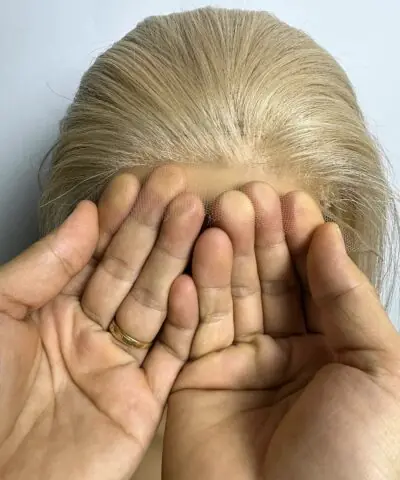 Blonde ombre wig closure held by hand
