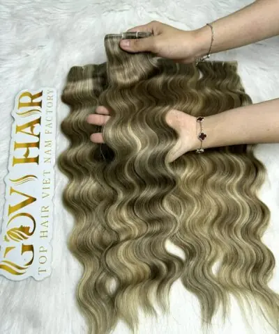 Genius wefts hair extensions mix piano held by hand