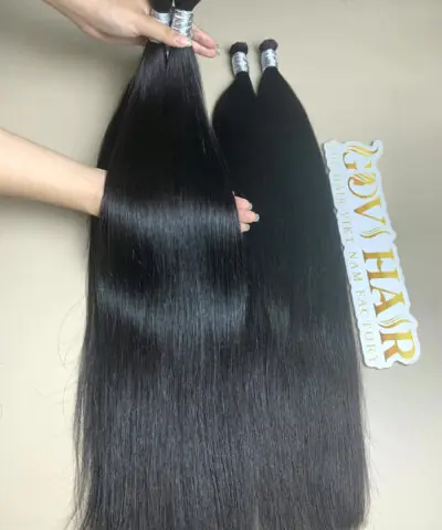 raw Vietnamese bulk hair held by hand showing shine