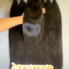 raw tape in hair extensions held by hand showing shine