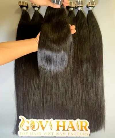 raw tape in hair extensions held by hand showing shine