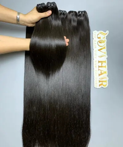 raw hair bundles held by hand showing shine
