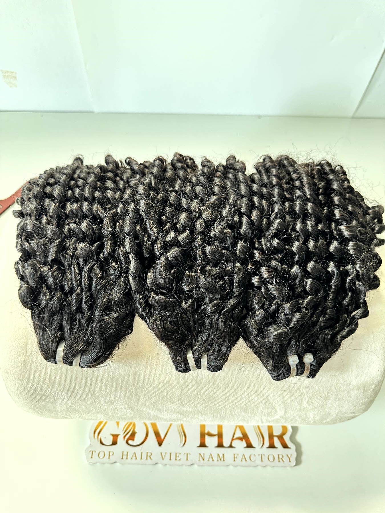 18 Inch Pixie Curly Hair Super Double Drawn Raw Bundles Wholesale 4 Pixie curly hair bundles top down view