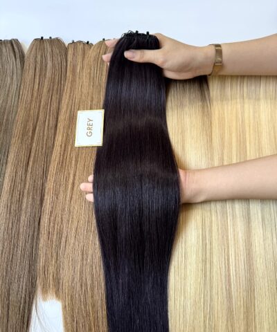 Grey feather weft hair extensions next to shade samples