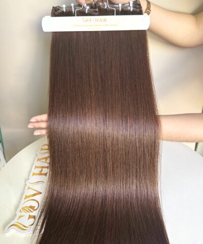 Genius weft hair #4 brown held by hand