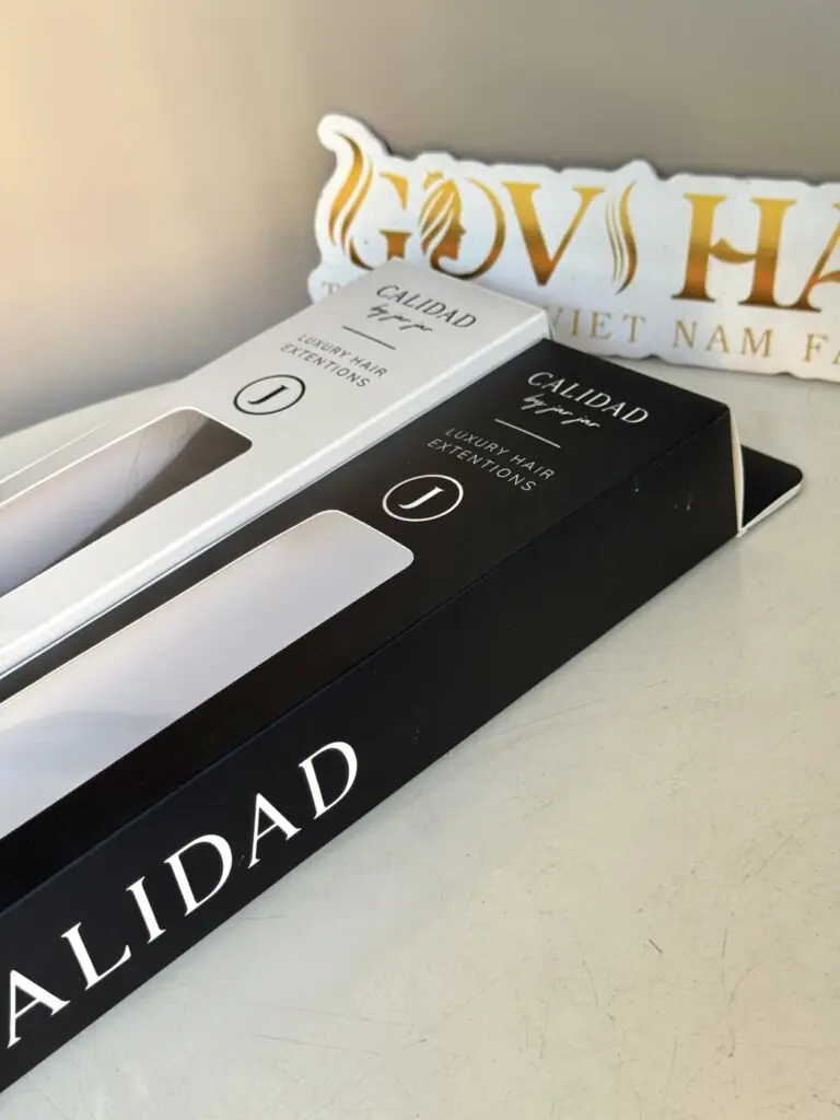Luxury black and white private label hair extension boxes in front of the Govihair sign