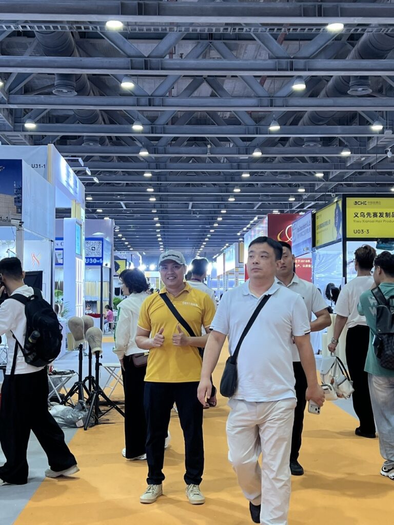 Tommy Huynh walking the exhibition hall at the 16th China Hair Expo, 2026