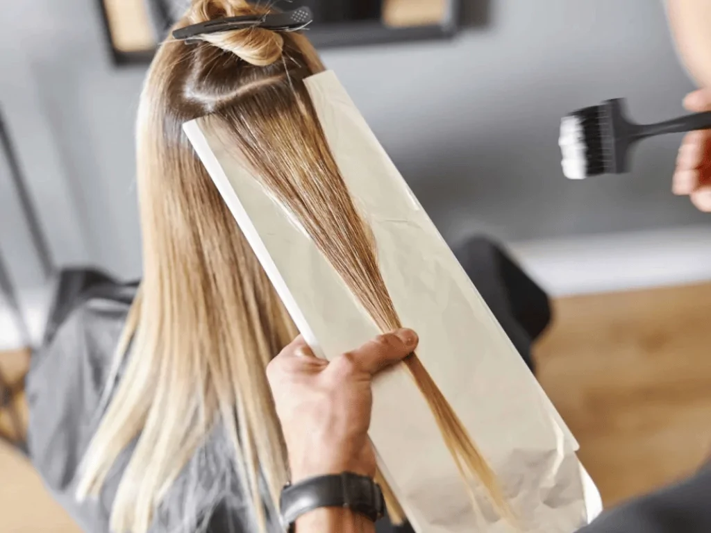 Stylist preparing to highlight human hair extensions