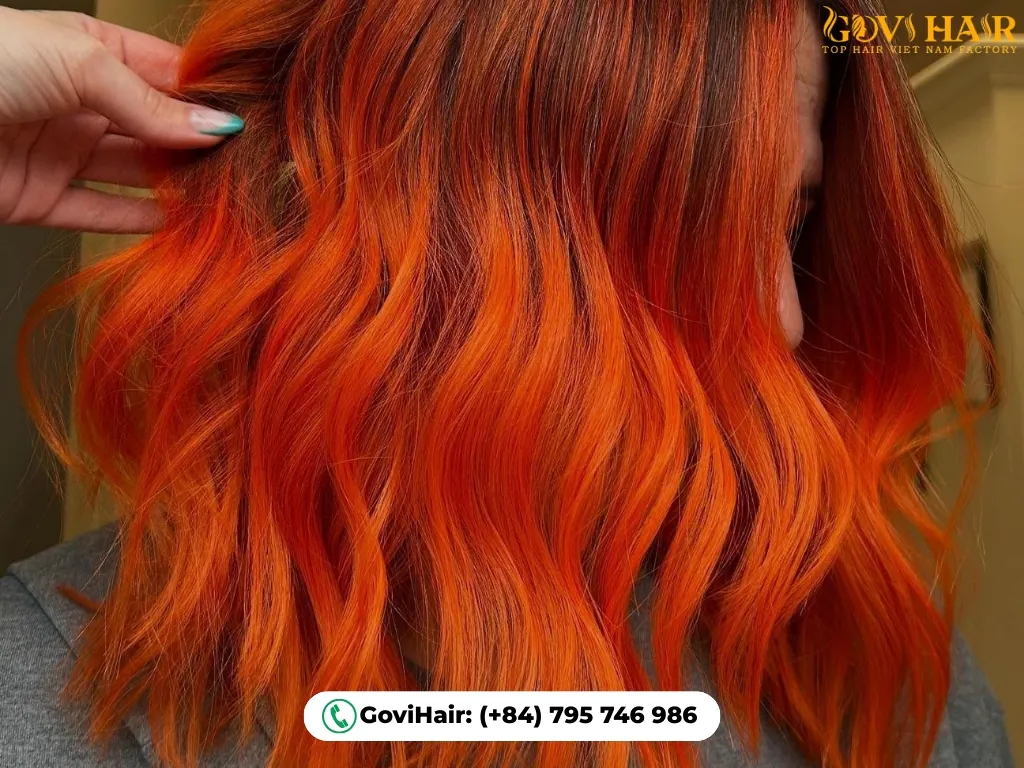 High-energy tangerine two-tone hair look