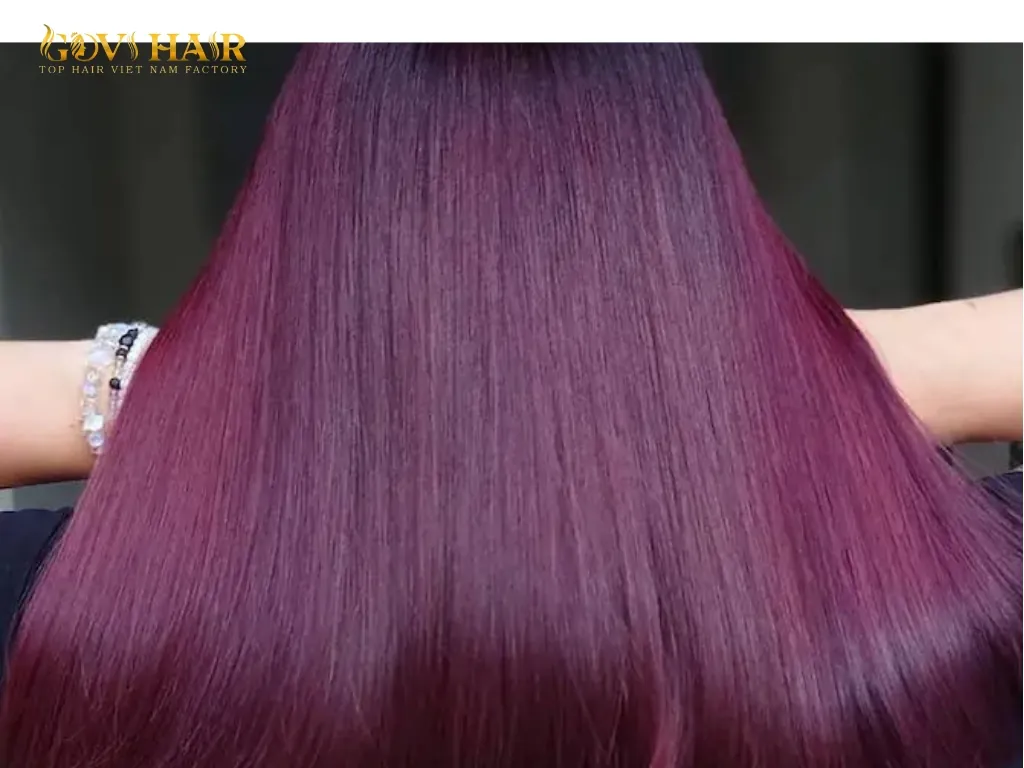 Cherry plum hair color showing rich red and subtle plum undertones under natural lighting