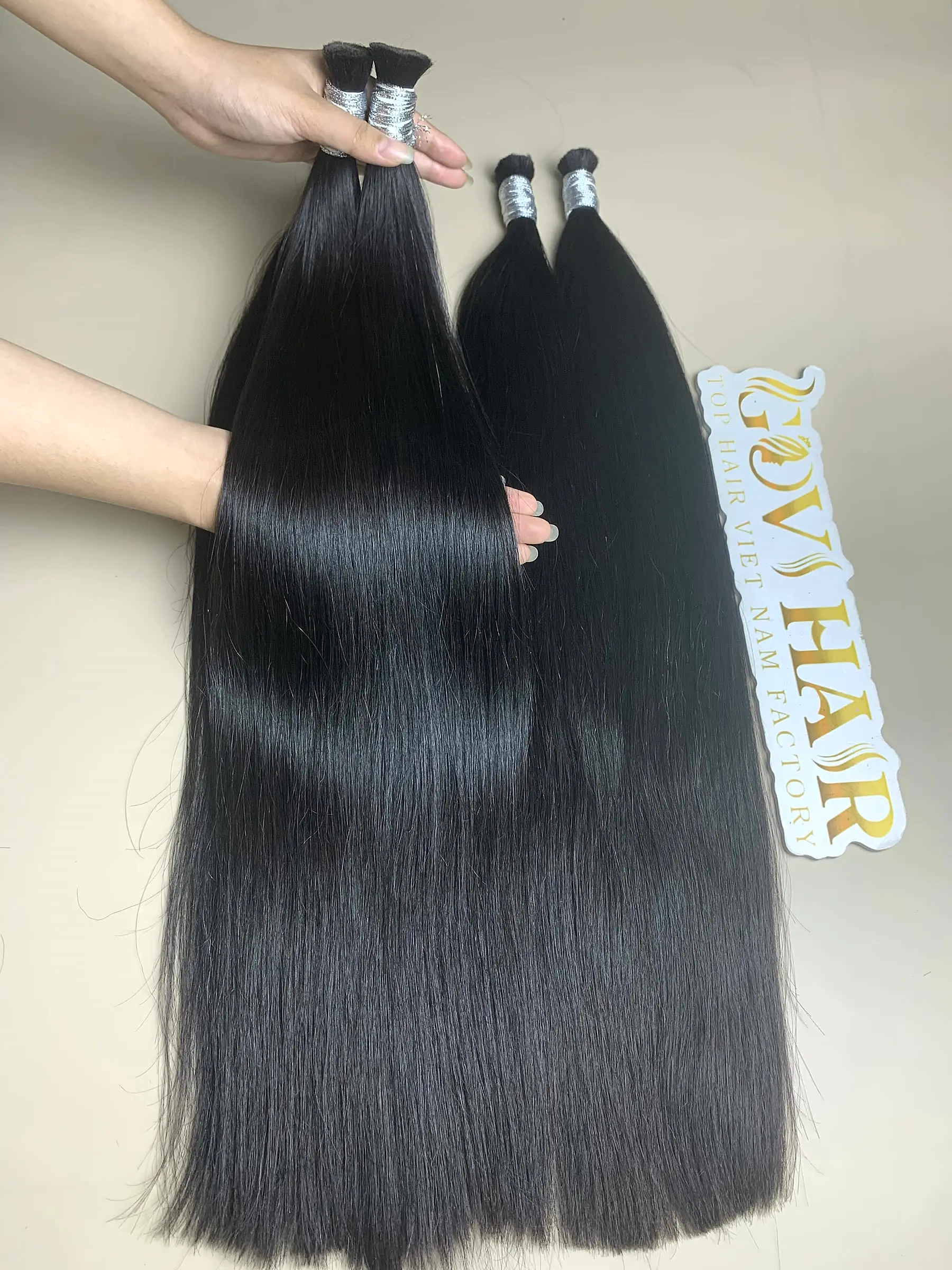 raw Vietnamese bulk hair held by hand showing shine