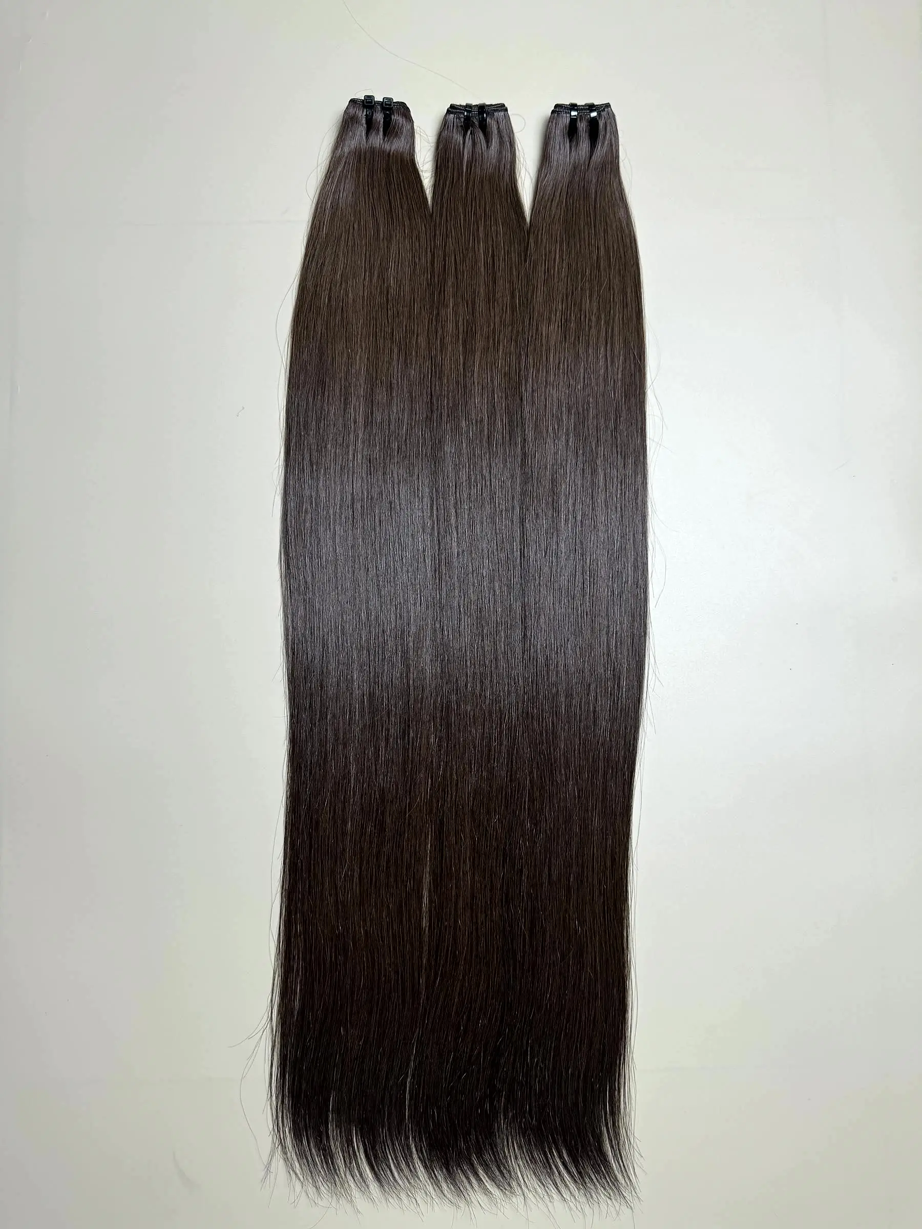 raw hair bundles in natural brown close up view 3