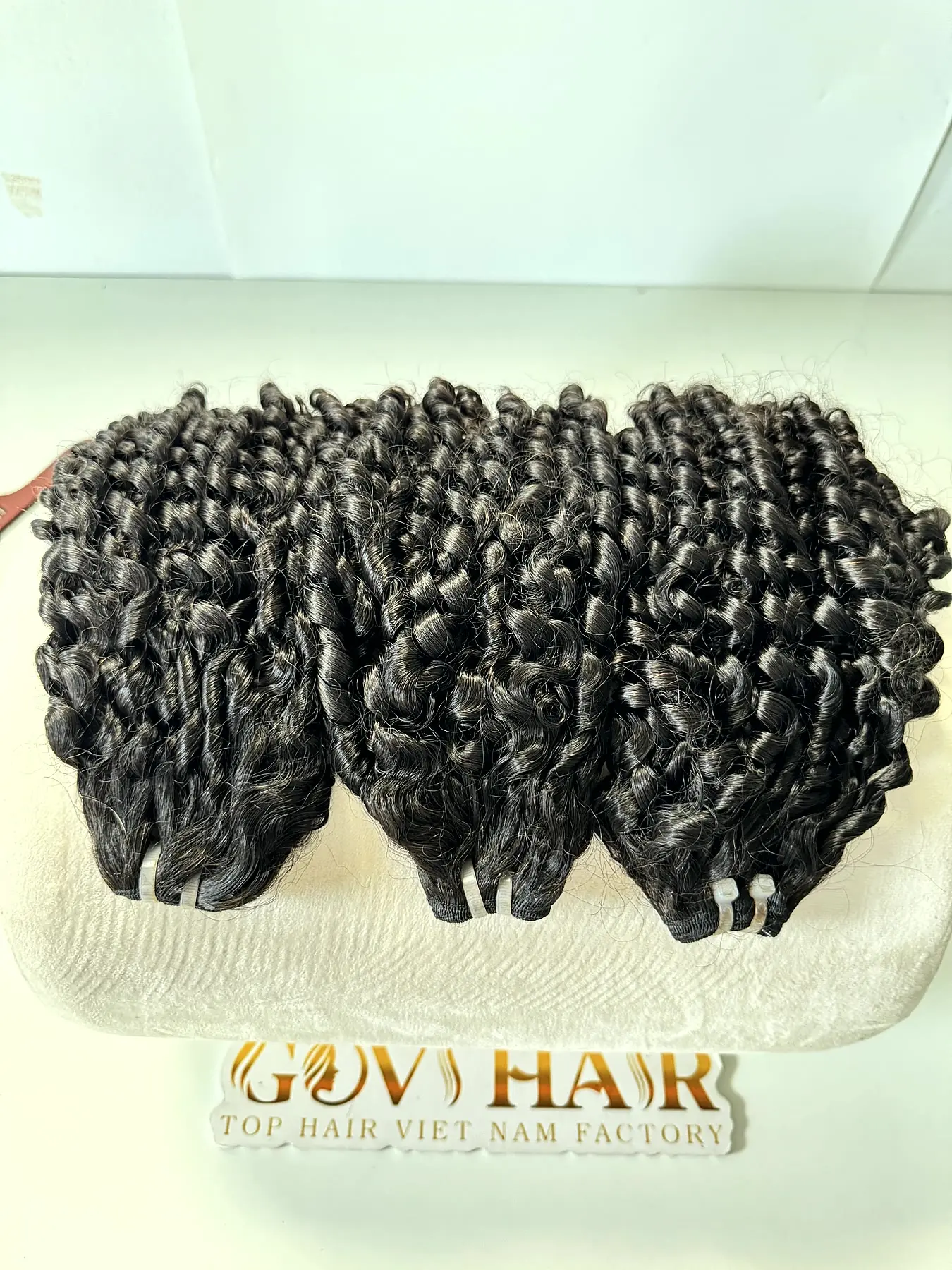 18 Inch Pixie Curly Hair Super Double Drawn Raw Bundles Wholesale 4 Pixie curly hair bundles top down view