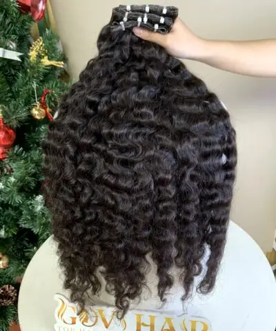 Curly weft extensions 26 inch held by hand