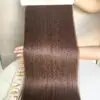 Genius weft hair #4 brown held by hand