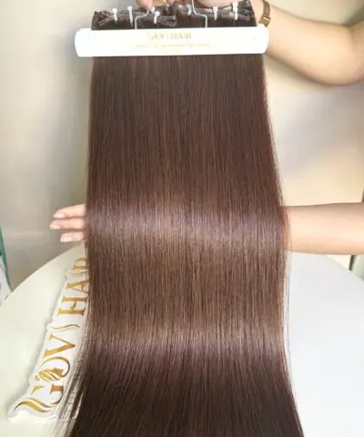 Genius weft hair #4 brown held by hand